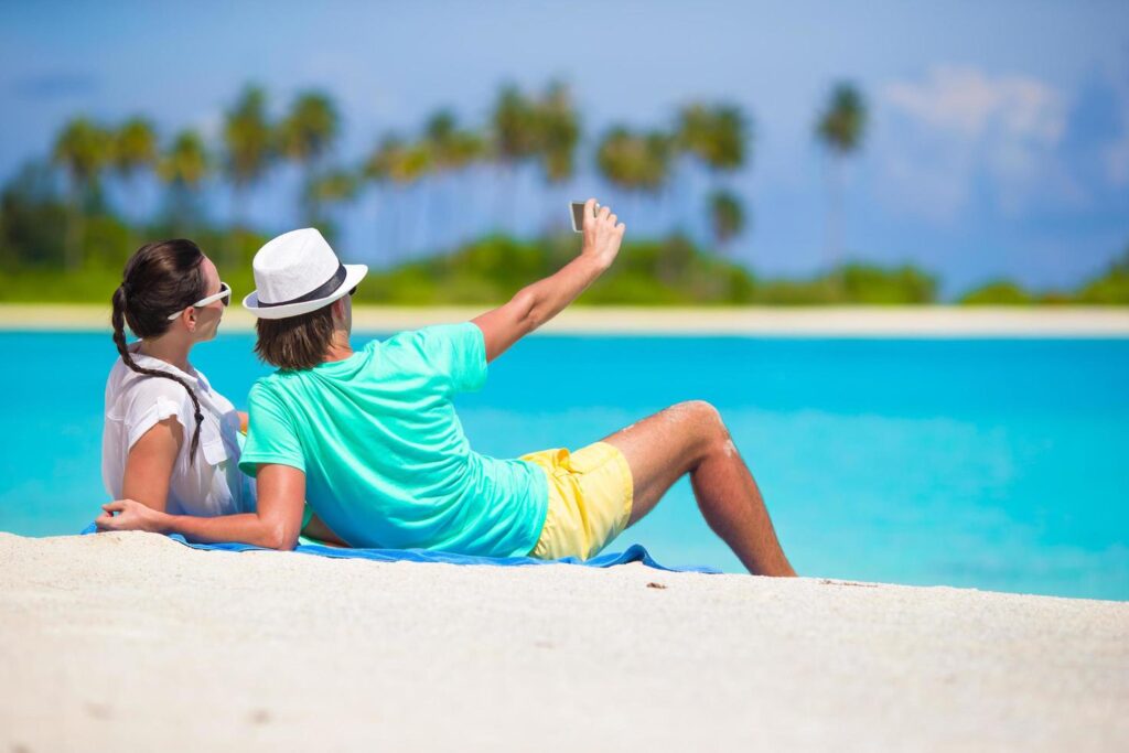 couple-taking-a-selfie-on-a-beach-free-photo